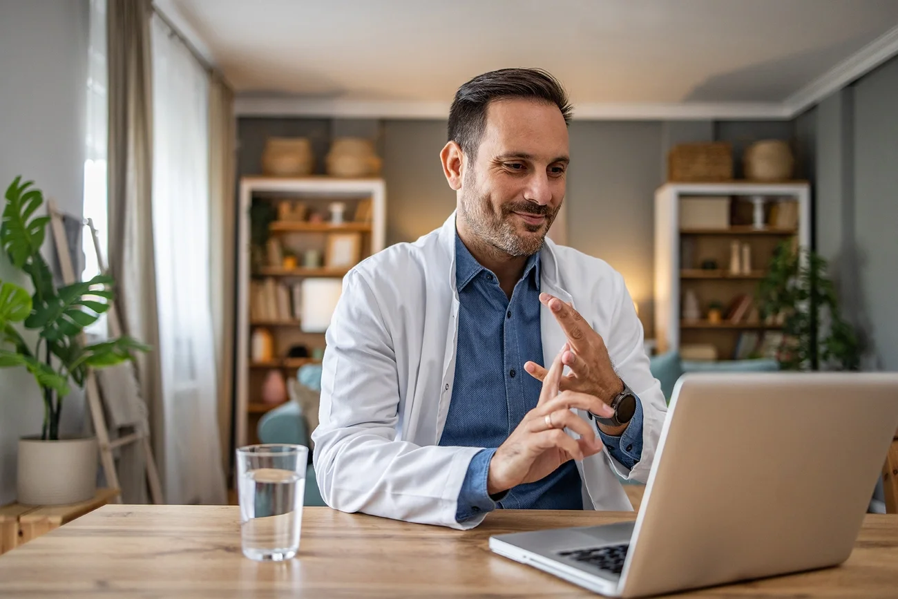 Physician giving hosting telemedicine appointment on laptop