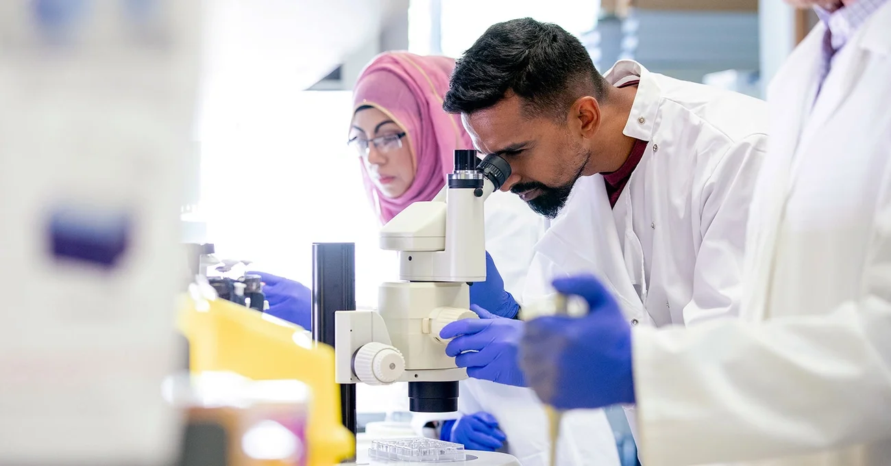 Scientist looking at microscope