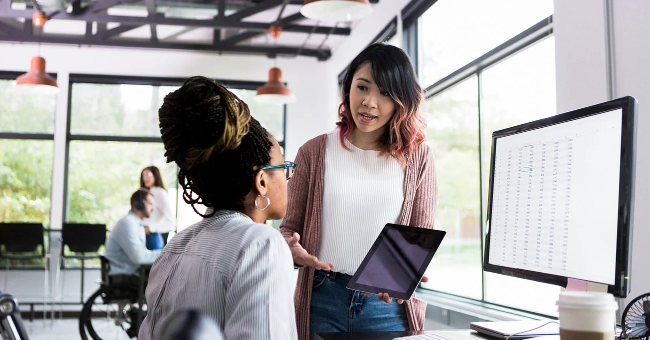 two colleagues working together in an office